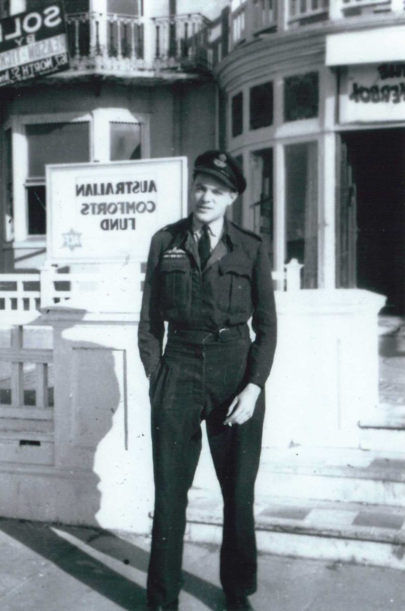 Bill Woods in RAAF uniform standing outside the Australian Comforts Fund building in England